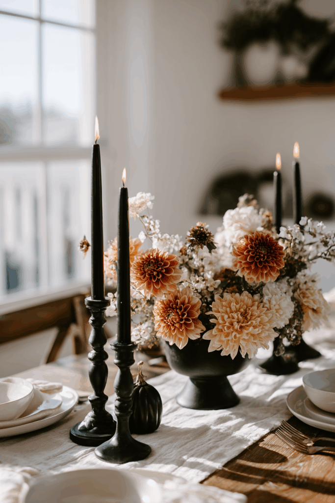 table centerpiece with candles, flowers and subtle Halloween elements