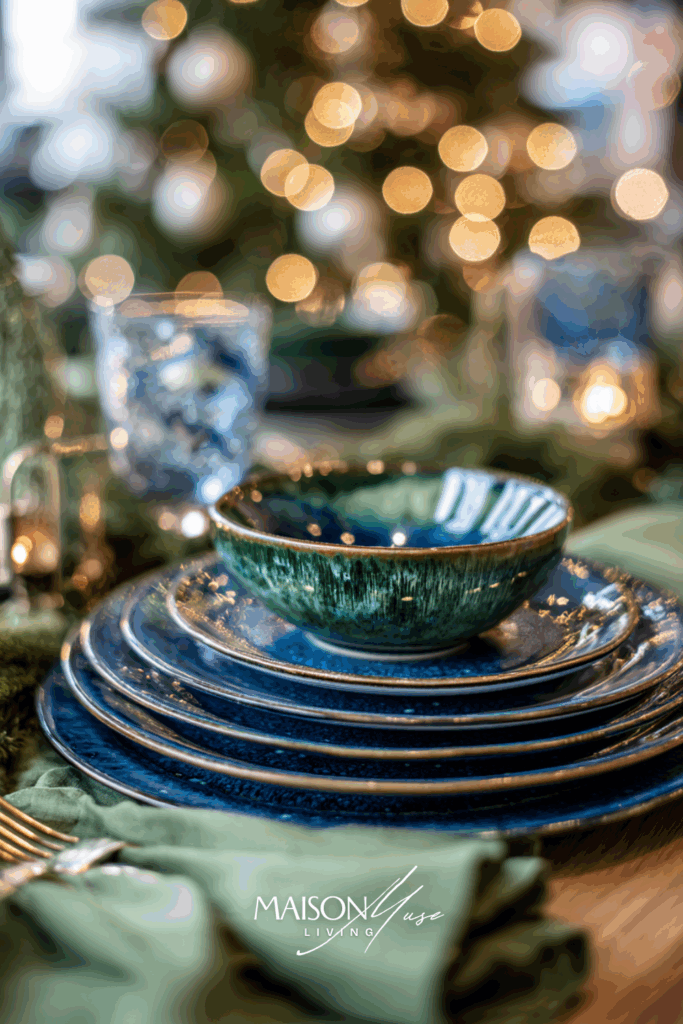 Christmas tablescape in deep blue and forest green color palette with pine branches and navy blue candles