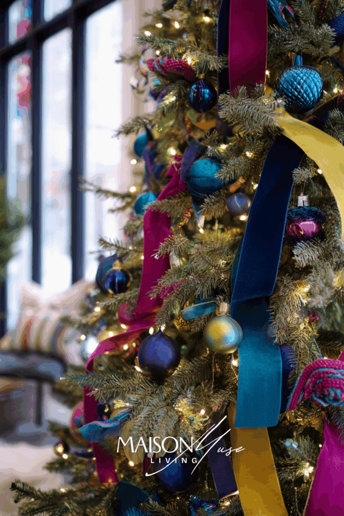 Christmas tree decorated in jewel tones, rich velvet ribbons, glowing fairy lights