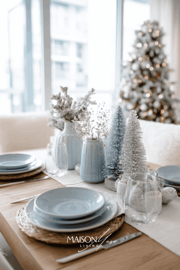 Scandinavian christmas table setting with white linen, dried flowers, baby blue candles, frosted ornaments