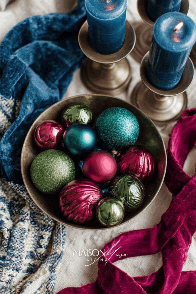flatlay of jewel tone Christmas palette, emerald and ruby ornaments
